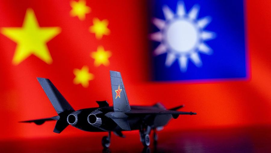 A model of the Chinese Fighter aircraft is seen in front of Chinese and Taiwanese flags in this illustration taken, April 28, 2022. Picture taken April 28, 2022. EUTERS/Dado Ruvic/Illustration