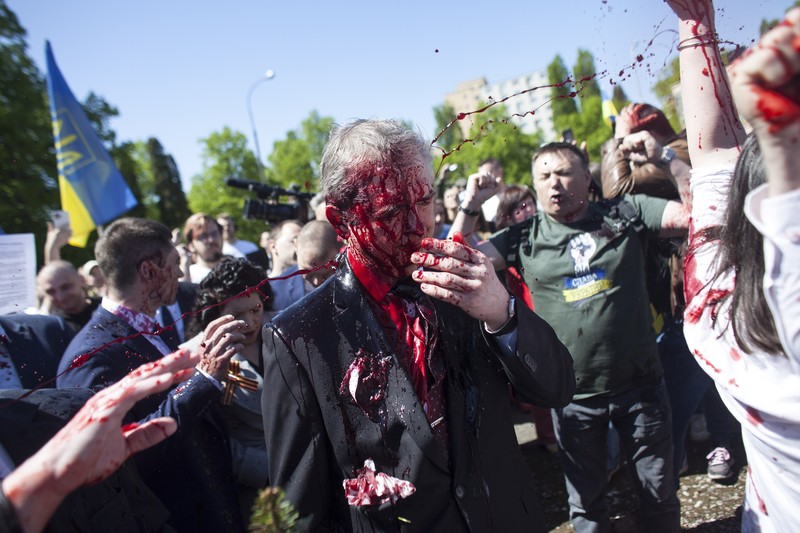 APTOPIX Poland Russia Ambassador Russian Ambassador to Poland, Ambassador Sergey Andreev is covered with red paint in Warsaw, Poland, Monday, May 9, 2022. Protesters have thrown red paint on the Russian ambassador as he arrived at a cemetery in Warsaw to pay respects to Red Army soldiers who died during World War II. Ambassador Sergey Andreev arrived at the Soviet soldiers cemetery on Monday to lay flowers where a group of activists opposed to Russia’s war in Ukraine were waiting for him. (AP Photo/Maciek Luczniewski)
