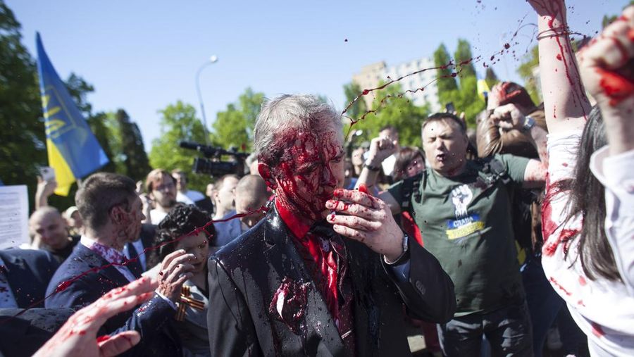 Russian Ambassador to Poland, Ambassador Sergey Andreev is covered with red paint in Warsaw, Poland, Monday, May 9, 2022. Protesters have thrown red paint on the Russian ambassador as he arrived at a cemetery in Warsaw to pay respects to Red Army soldiers who died during World War II. Ambassador Sergey Andreev arrived at the Soviet soldiers cemetery on Monday to lay flowers where a group of activists opposed to Russia’s war in Ukraine were waiting for him. (AP Photo/Maciek Luczniewski)