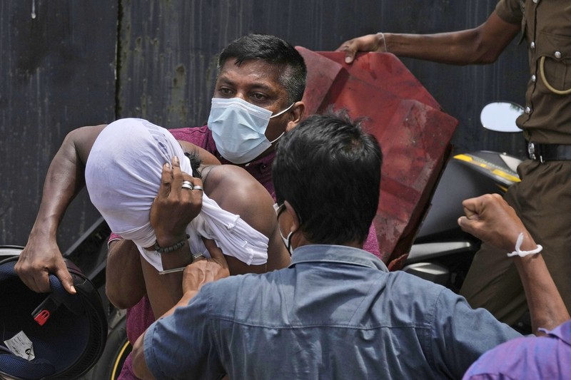 Sri Lanka Economic Crisis Sri Lanka's pro government and anti government protestors clash as police fires water canons outside the president's office in Colombo, Sri Lanka, Monday, May 9, 2022. Government supporters on Monday attacked protesters who have been camped outside the office of Sri Lanka's prime minster, as trade unions began a
