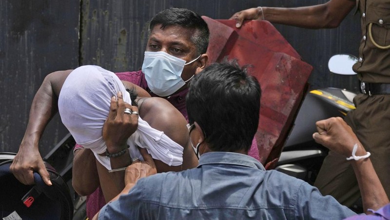 Sri Lanka's pro government and anti government protestors clash as police fires water canons outside the president's office in Colombo, Sri Lanka, Monday, May 9, 2022. Government supporters on Monday attacked protesters who have been camped outside the office of Sri Lanka's prime minster, as trade unions began a 