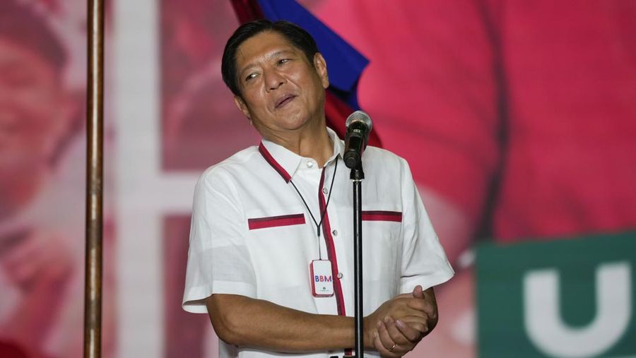FILE - Presidential candidate, Ferdinand Marcos Jr., the son of the late dictator, reacts to the crowd at their last campaign rally known as