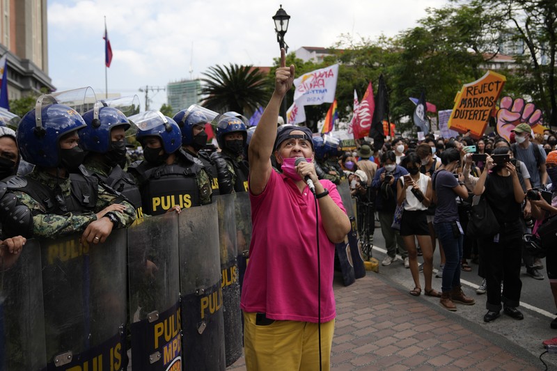 PHILIPPINES-ELECTION/PROTESTS Students and activists march outside the Commission on Elections to protest its unofficial tally of the national elections, showing presidential candidate Ferdinand