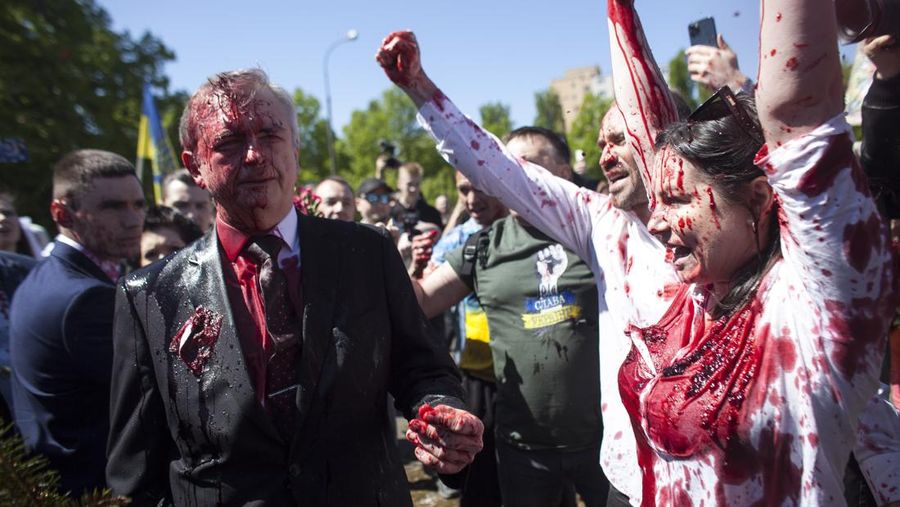 Russian Ambassador to Poland, Ambassador Sergey Andreev is covered with red paint in Warsaw, Poland, Monday, May 9, 2022. Protesters have thrown red paint on the Russian ambassador as he arrived at a cemetery in Warsaw to pay respects to Red Army soldiers who died during World War II. Ambassador Sergey Andreev arrived at the Soviet soldiers cemetery on Monday to lay flowers where a group of activists opposed to Russia’s war in Ukraine were waiting for him. (AP Photo/Maciek Luczniewski)