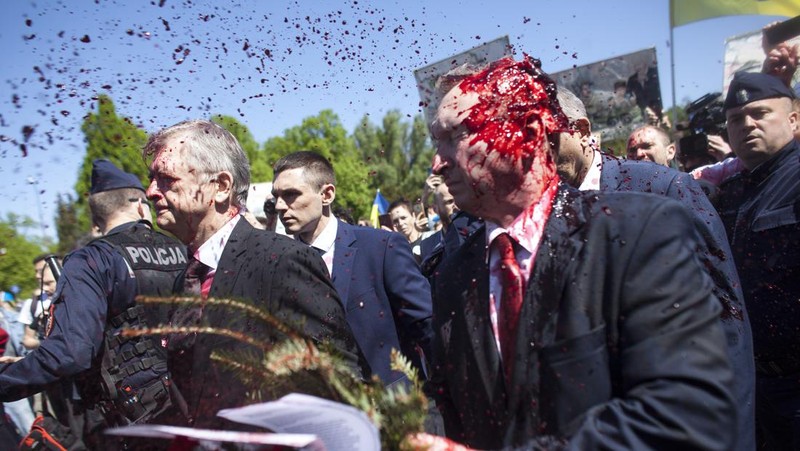 Russian Ambassador to Poland, Ambassador Sergey Andreev is covered with red paint in Warsaw, Poland, Monday, May 9, 2022. Protesters have thrown red paint on the Russian ambassador as he arrived at a cemetery in Warsaw to pay respects to Red Army soldiers who died during World War II. Ambassador Sergey Andreev arrived at the Soviet soldiers cemetery on Monday to lay flowers where a group of activists opposed to Russia’s war in Ukraine were waiting for him. (AP Photo/Maciek Luczniewski)