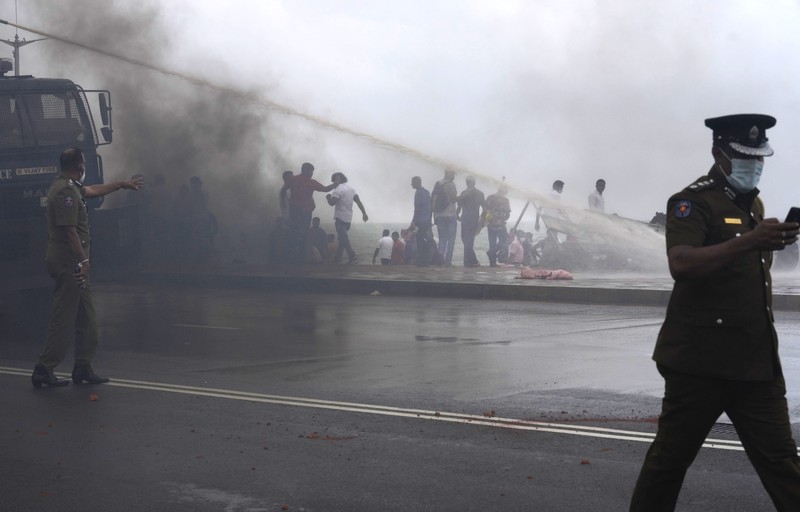 Sri Lanka Economic Crisis Sri Lanka's pro government and anti government protestors clash as police fires water canons outside the president's office in Colombo, Sri Lanka, Monday, May 9, 2022. Government supporters on Monday attacked protesters who have been camped outside the office of Sri Lanka's prime minster, as trade unions began a