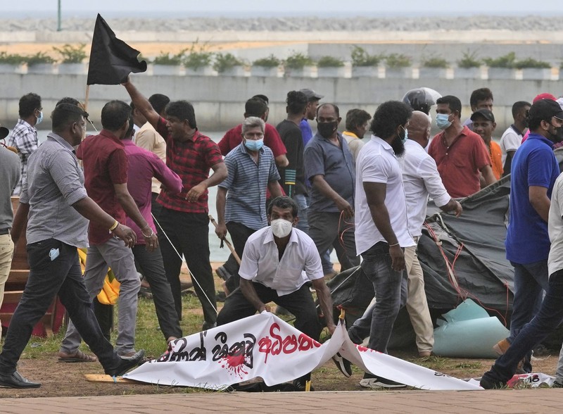 Sri Lanka Economic Crisis Sri Lanka's pro government and anti government protestors clash as police fires water canons outside the president's office in Colombo, Sri Lanka, Monday, May 9, 2022. Government supporters on Monday attacked protesters who have been camped outside the office of Sri Lanka's prime minster, as trade unions began a