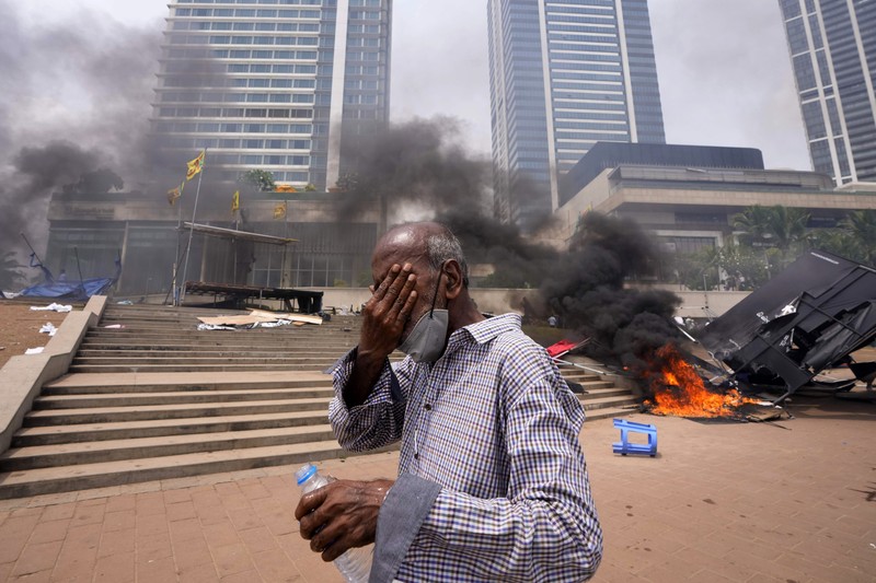 Sri Lanka Economic Crisis Sri Lanka's pro government and anti government protestors clash as police fires water canons outside the president's office in Colombo, Sri Lanka, Monday, May 9, 2022. Government supporters on Monday attacked protesters who have been camped outside the office of Sri Lanka's prime minster, as trade unions began a