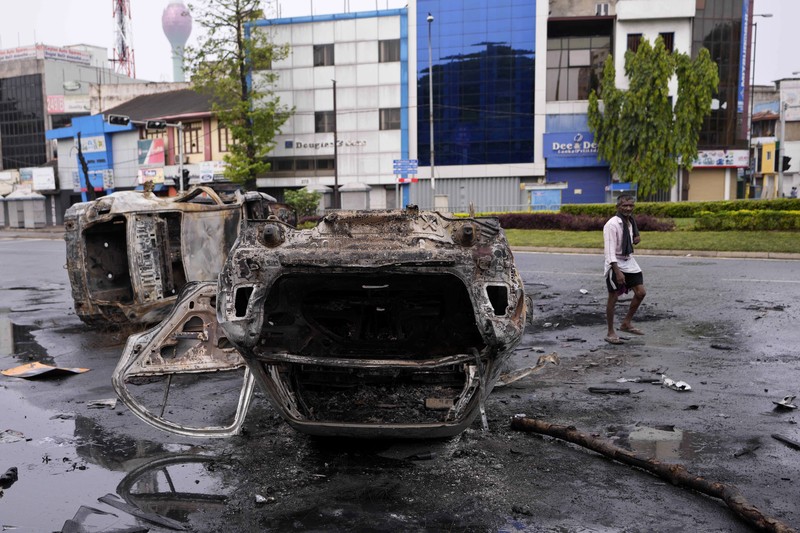 Sri Lanka's pro government and anti government protestors clash as police fires water canons outside the president's office in Colombo, Sri Lanka, Monday, May 9, 2022. Government supporters on Monday attacked protesters who have been camped outside the office of Sri Lanka's prime minster, as trade unions began a 