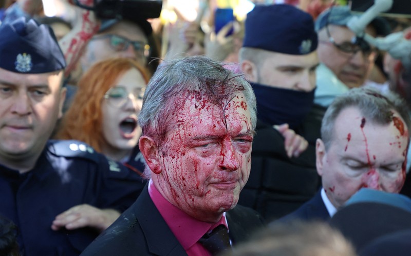 APTOPIX Poland Russia Ambassador Russian Ambassador to Poland, Ambassador Sergey Andreev is covered with red paint in Warsaw, Poland, Monday, May 9, 2022. Protesters have thrown red paint on the Russian ambassador as he arrived at a cemetery in Warsaw to pay respects to Red Army soldiers who died during World War II. Ambassador Sergey Andreev arrived at the Soviet soldiers cemetery on Monday to lay flowers where a group of activists opposed to Russia’s war in Ukraine were waiting for him. (AP Photo/Maciek Luczniewski)