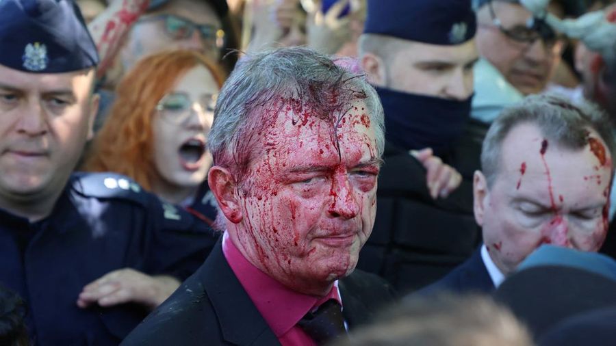 Russian Ambassador to Poland, Ambassador Sergey Andreev is covered with red paint in Warsaw, Poland, Monday, May 9, 2022. Protesters have thrown red paint on the Russian ambassador as he arrived at a cemetery in Warsaw to pay respects to Red Army soldiers who died during World War II. Ambassador Sergey Andreev arrived at the Soviet soldiers cemetery on Monday to lay flowers where a group of activists opposed to Russia’s war in Ukraine were waiting for him. (AP Photo/Maciek Luczniewski)
