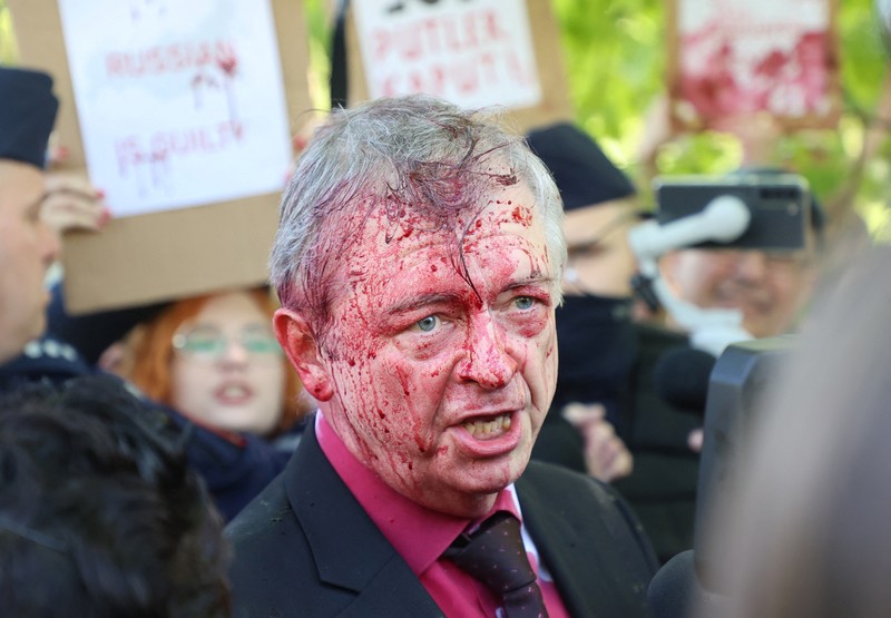 APTOPIX Poland Russia Ambassador Russian Ambassador to Poland, Ambassador Sergey Andreev is covered with red paint in Warsaw, Poland, Monday, May 9, 2022. Protesters have thrown red paint on the Russian ambassador as he arrived at a cemetery in Warsaw to pay respects to Red Army soldiers who died during World War II. Ambassador Sergey Andreev arrived at the Soviet soldiers cemetery on Monday to lay flowers where a group of activists opposed to Russia’s war in Ukraine were waiting for him. (AP Photo/Maciek Luczniewski)