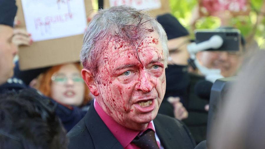 Russian Ambassador to Poland, Ambassador Sergey Andreev is covered with red paint in Warsaw, Poland, Monday, May 9, 2022. Protesters have thrown red paint on the Russian ambassador as he arrived at a cemetery in Warsaw to pay respects to Red Army soldiers who died during World War II. Ambassador Sergey Andreev arrived at the Soviet soldiers cemetery on Monday to lay flowers where a group of activists opposed to Russia’s war in Ukraine were waiting for him. (AP Photo/Maciek Luczniewski)