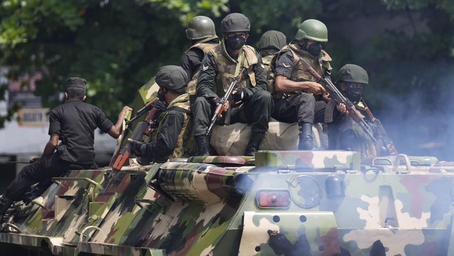 Army members travel on an armoured car on the main road after the curfew was extended for another extra day following a clash between Anti-government demonstrators and Sri Lanka's ruling party supporters, amid the country's economic crisis, in Colombo, Sri Lanka, May 11, 2022. REUTERS/Dinuka Liyanawatte