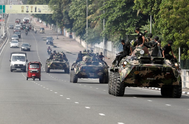 SRI LANKA-CRISIS/ Army members travel on an armoured car on the main road after the curfew was extended for another extra day following a clash between Anti-government demonstrators and Sri Lanka's ruling party supporters, amid the country's economic crisis, in Colombo, Sri Lanka, May 11, 2022. REUTERS/Dinuka Liyanawatte