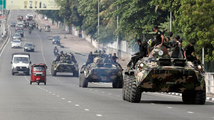 Army members travel on an armoured car on the main road after the curfew was extended for another extra day following a clash between Anti-government demonstrators and Sri Lanka's ruling party supporters, amid the country's economic crisis, in Colombo, Sri Lanka, May 11, 2022. REUTERS/Dinuka Liyanawatte