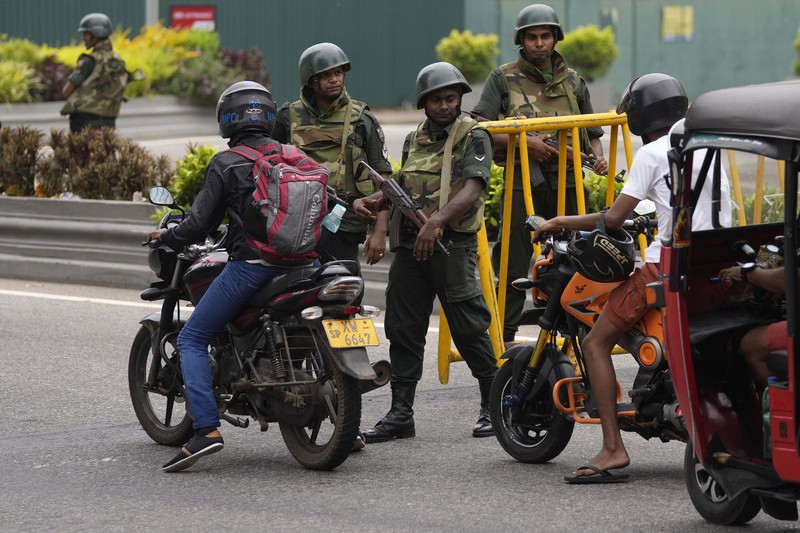 Army members travel on an armoured car on the main road after the curfew was extended for another extra day following a clash between Anti-government demonstrators and Sri Lanka's ruling party supporters, amid the country's economic crisis, in Colombo, Sri Lanka, May 11, 2022. REUTERS/Dinuka Liyanawatte
