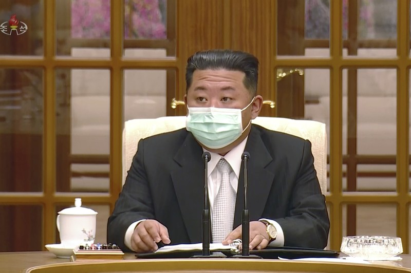 A passerby walks past a screen displaying an image of North Korean leader Kim Jong Un wearing a face mask on a TV news program in Tokyo, Friday, May 13, 2022. North Korea imposed a nationwide lockdown Thursday to control its first acknowledged COVID-19 outbreak after holding for more than two years to a widely doubted claim of a perfect record keeping out the virus that has spread to nearly every place in the world.(AP Photo/Shuji Kajiyama)