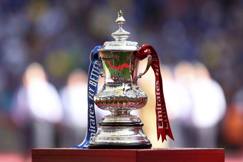 Liverpool players hold the trophy and celebrate after winning the English FA Cup final soccer match between Chelsea and Liverpool, at Wembley stadium, in London, Saturday, May 14, 2022. (AP Photo/Kirsty Wigglesworth)