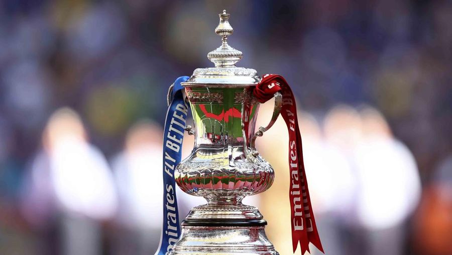 Liverpool players hold the trophy and celebrate after winning the English FA Cup final soccer match between Chelsea and Liverpool, at Wembley stadium, in London, Saturday, May 14, 2022. (AP Photo/Kirsty Wigglesworth)