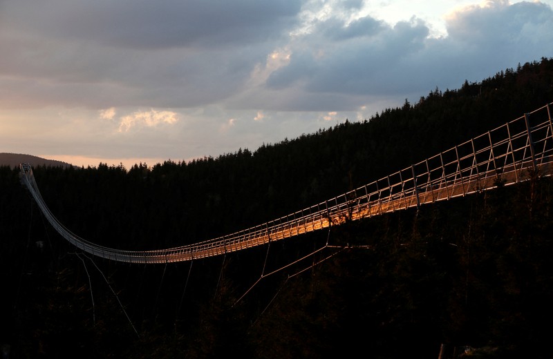 People walk across the newly-built world's longest suspension bridge after its official opening in the mountain resort of Dolni Morava, Czech Republic, May 13, 2022. REUTERS/David W Cerny *** Local Caption *** CAPTION TEST 01