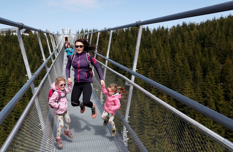 CZECH-BRIDGE/ People walk across the newly-built world's longest suspension bridge after its official opening in the mountain resort of Dolni Morava, Czech Republic, May 13, 2022. REUTERS/David W Cerny *** Local Caption *** CAPTION TEST 01