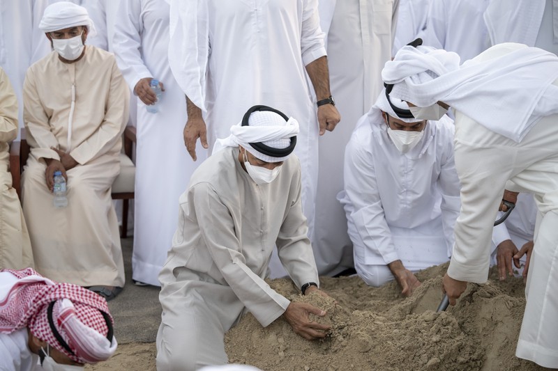 Emirates Leader Funeral This photo made available by the Ministry of Presidential Affairs, shows UAE Crown Prince Sheikh Mohamed bin Zayed Al Nahyan, ruler of Abu Dhabi, front right, and Sheikh Mansour bin Zayed Al Nahyan, UAE Deputy Prime Minister and Minister of Presidential Affairs, front left, carry the body of Sheikh Khalifa bin Zayed Al Nahyan, president of the United Arab Emirates, with other members of royal family at Sheikh Sultan bin Zayed The First mosque, in Abu Dhabi, Friday, May 13, 2022. (Abdulla Al Neyadi/Ministry of Presidential Affairs via AP)