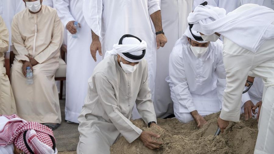 This photo made available by the Ministry of Presidential Affairs, shows Sheikh Mohamed bin Zayed Al Nahyan, ruler of Abu Dhabi, front left, and Sheikh Mansour bin Zayed Al Nahyan, UAE Deputy Prime Minister and Minister of Presidential Affairs, front right, carry the body of Sheikh Khalifa bin Zayed Al Nahyan, president of the United Arab Emirates, with other members of royal family at Sheikh Sultan bin Zayed The First mosque, in Abu Dhabi, Friday, May 13, 2022. (Hamad Al Kaabi/Ministry of Presidential Affairs via AP)
