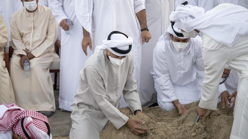This photo made available by the Ministry of Presidential Affairs, shows Sheikh Mohamed bin Zayed Al Nahyan, ruler of Abu Dhabi, front left, and Sheikh Mansour bin Zayed Al Nahyan, UAE Deputy Prime Minister and Minister of Presidential Affairs, front right, carry the body of Sheikh Khalifa bin Zayed Al Nahyan, president of the United Arab Emirates, with other members of royal family at Sheikh Sultan bin Zayed The First mosque, in Abu Dhabi, Friday, May 13, 2022. (Hamad Al Kaabi/Ministry of Presidential Affairs via AP)