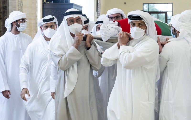 This photo made available by the Ministry of Presidential Affairs, shows UAE Crown Prince Sheikh Mohamed bin Zayed Al Nahyan, ruler of Abu Dhabi, front right, and Sheikh Mansour bin Zayed Al Nahyan, UAE Deputy Prime Minister and Minister of Presidential Affairs, front left, carry the body of Sheikh Khalifa bin Zayed Al Nahyan, president of the United Arab Emirates, with other members of royal family at Sheikh Sultan bin Zayed The First mosque, in Abu Dhabi, Friday, May 13, 2022. (Abdulla Al Neyadi/Ministry of Presidential Affairs via AP)