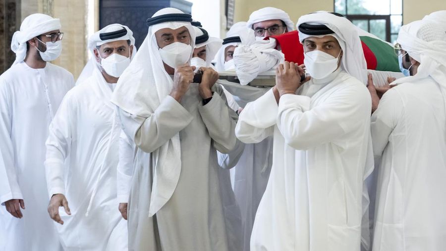 This photo made available by the Ministry of Presidential Affairs, shows Sheikh Mohamed bin Zayed Al Nahyan, ruler of Abu Dhabi, front left, and Sheikh Mansour bin Zayed Al Nahyan, UAE Deputy Prime Minister and Minister of Presidential Affairs, front right, carry the body of Sheikh Khalifa bin Zayed Al Nahyan, president of the United Arab Emirates, with other members of royal family at Sheikh Sultan bin Zayed The First mosque, in Abu Dhabi, Friday, May 13, 2022. (Hamad Al Kaabi/Ministry of Presidential Affairs via AP)