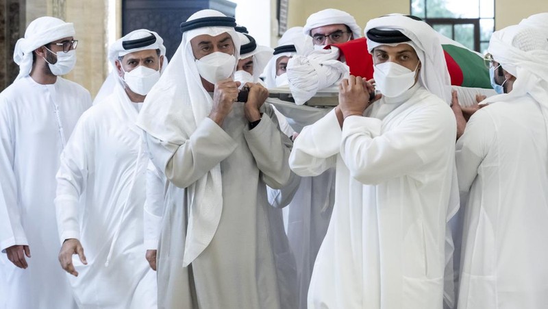 This photo made available by the Ministry of Presidential Affairs, shows Sheikh Mohamed bin Zayed Al Nahyan, ruler of Abu Dhabi, front left, and Sheikh Mansour bin Zayed Al Nahyan, UAE Deputy Prime Minister and Minister of Presidential Affairs, front right, carry the body of Sheikh Khalifa bin Zayed Al Nahyan, president of the United Arab Emirates, with other members of royal family at Sheikh Sultan bin Zayed The First mosque, in Abu Dhabi, Friday, May 13, 2022. (Hamad Al Kaabi/Ministry of Presidential Affairs via AP)