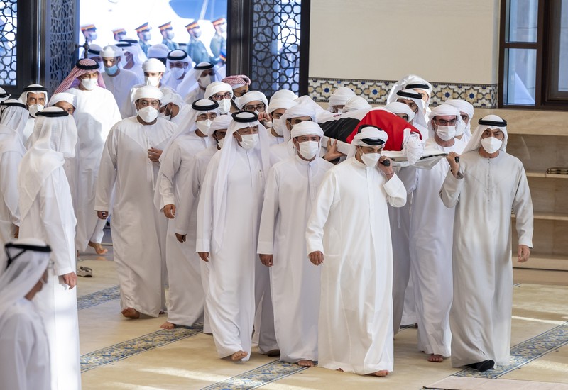 Emirates Leader Funeral This photo made available by the Ministry of Presidential Affairs, shows UAE Crown Prince Sheikh Mohamed bin Zayed Al Nahyan, ruler of Abu Dhabi, front right, and Sheikh Mansour bin Zayed Al Nahyan, UAE Deputy Prime Minister and Minister of Presidential Affairs, front left, carry the body of Sheikh Khalifa bin Zayed Al Nahyan, president of the United Arab Emirates, with other members of royal family at Sheikh Sultan bin Zayed The First mosque, in Abu Dhabi, Friday, May 13, 2022. (Abdulla Al Neyadi/Ministry of Presidential Affairs via AP)