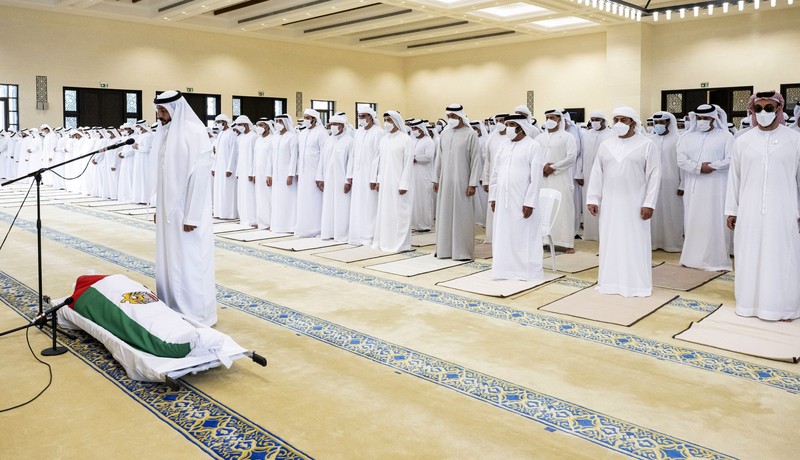 This photo made available by the Ministry of Presidential Affairs, shows UAE Crown Prince Sheikh Mohamed bin Zayed Al Nahyan, ruler of Abu Dhabi, front right, and Sheikh Mansour bin Zayed Al Nahyan, UAE Deputy Prime Minister and Minister of Presidential Affairs, front left, carry the body of Sheikh Khalifa bin Zayed Al Nahyan, president of the United Arab Emirates, with other members of royal family at Sheikh Sultan bin Zayed The First mosque, in Abu Dhabi, Friday, May 13, 2022. (Abdulla Al Neyadi/Ministry of Presidential Affairs via AP)