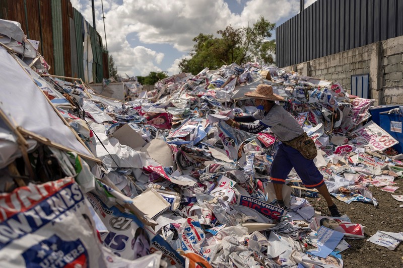 A worker sorts through piles of campaign posters left over from the national election at a recylcing facility in Marikina City, Philippines, May 12, 2022. REUTERS/Eloisa Lopez