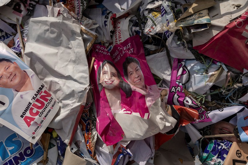 A worker sorts through piles of campaign posters left over from the national election at a recylcing facility in Marikina City, Philippines, May 12, 2022. REUTERS/Eloisa Lopez