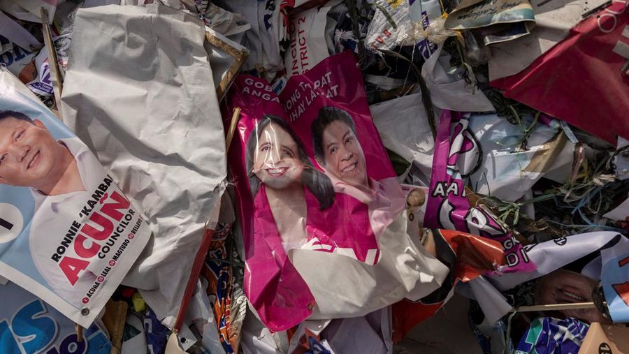 A worker sorts through piles of campaign posters left over from the national election at a recylcing facility in Marikina City, Philippines, May 12, 2022. REUTERS/Eloisa Lopez