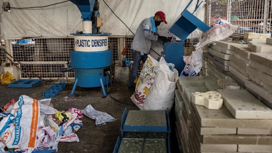 A worker sorts through piles of campaign posters left over from the national election at a recylcing facility in Marikina City, Philippines, May 12, 2022. REUTERS/Eloisa Lopez
