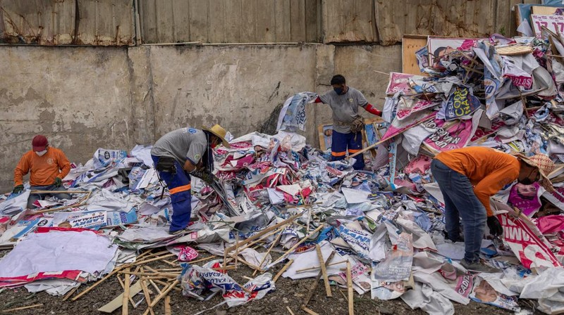 A worker sorts through piles of campaign posters left over from the national election at a recylcing facility in Marikina City, Philippines, May 12, 2022. REUTERS/Eloisa Lopez