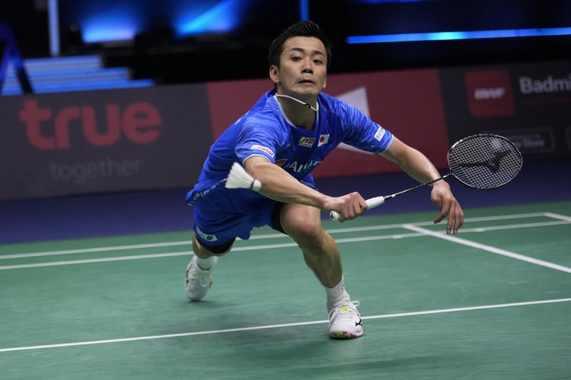 Thailand Badminton Thomas & Uber Indonesia's Anthony Ginting returns a shot to Japan's Kento Momota during their men's single semi-final match at Thomas & Uber Cup in Bangkok, Thailand, Friday, May 13, 2022. (AP Photo/Sakchai Lalit)