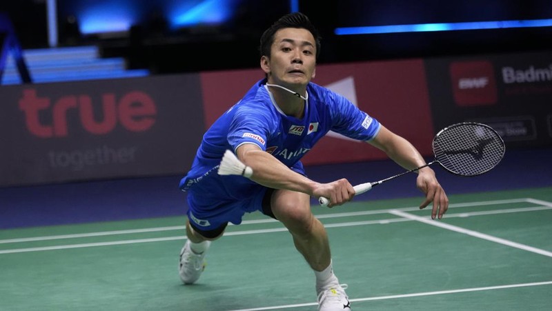 Indonesia's Anthony Ginting returns a shot to Japan's Kento Momota during their men's single semi-final match at Thomas & Uber Cup in Bangkok, Thailand, Friday, May 13, 2022. (AP Photo/Sakchai Lalit)