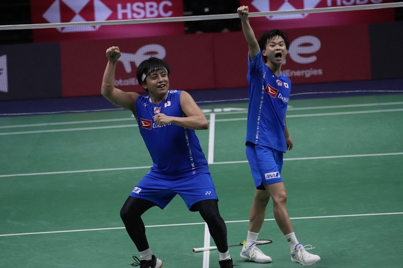 Indonesia's Anthony Ginting returns a shot to Japan's Kento Momota during their men's single semi-final match at Thomas & Uber Cup in Bangkok, Thailand, Friday, May 13, 2022. (AP Photo/Sakchai Lalit)