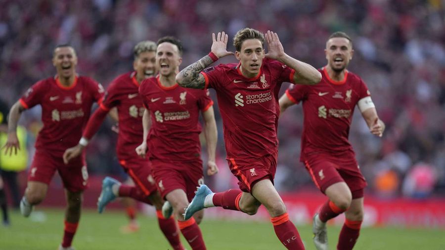 Liverpool players hold the trophy and celebrate after winning the English FA Cup final soccer match between Chelsea and Liverpool, at Wembley stadium, in London, Saturday, May 14, 2022. (AP Photo/Kirsty Wigglesworth)
