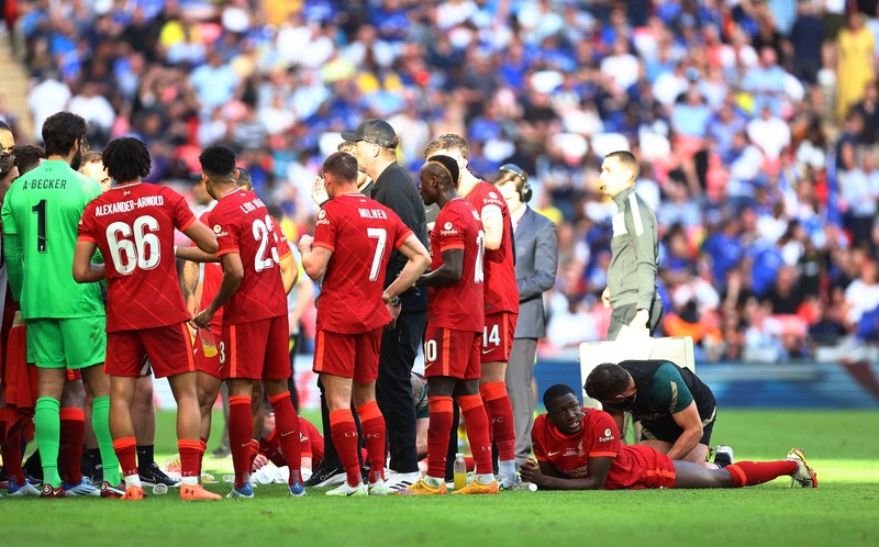 Liverpool players hold the trophy and celebrate after winning the English FA Cup final soccer match between Chelsea and Liverpool, at Wembley stadium, in London, Saturday, May 14, 2022. (AP Photo/Kirsty Wigglesworth)