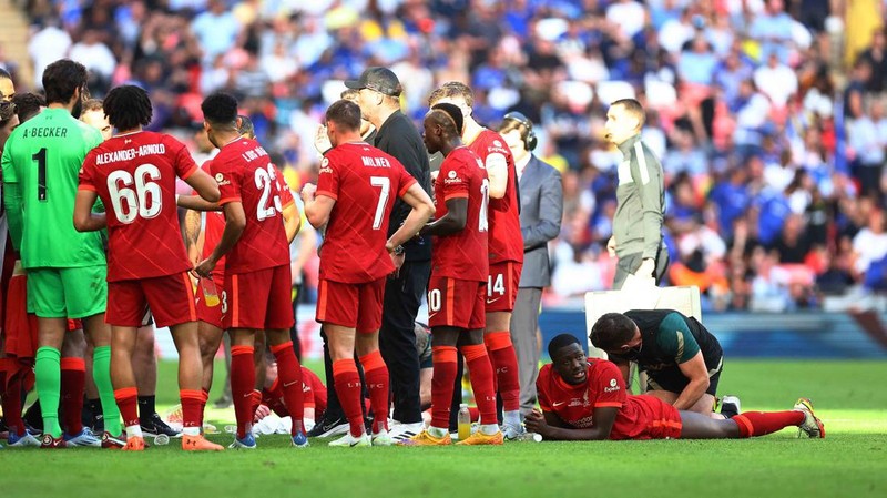 Liverpool players hold the trophy and celebrate after winning the English FA Cup final soccer match between Chelsea and Liverpool, at Wembley stadium, in London, Saturday, May 14, 2022. (AP Photo/Kirsty Wigglesworth)