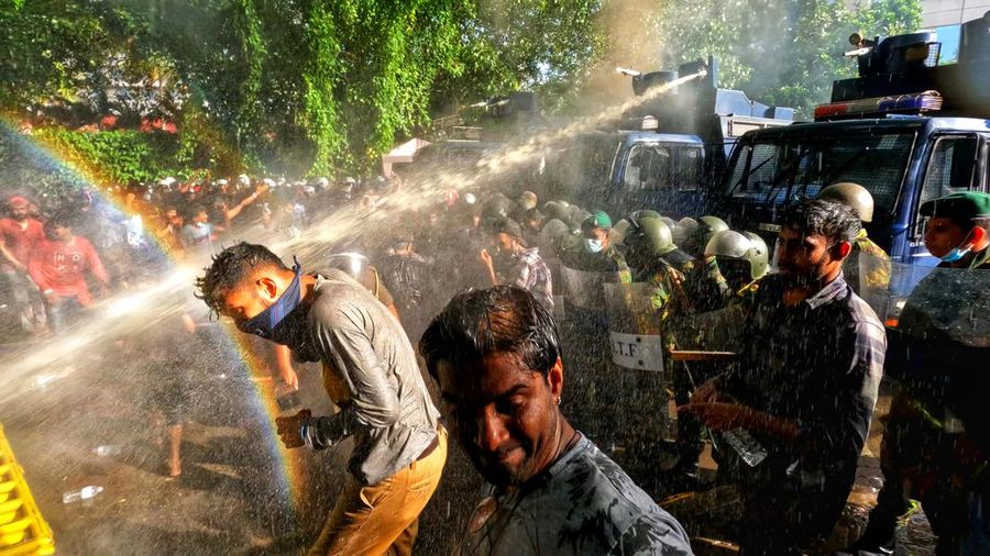 Mahasiswa Sri Lanka melarikan diri dari meriam air dan gas air mata saat para pengunjuk rasa bentrok dengan polisi melawan pemerintah di dekat kediaman resmi presiden Gotabaya Rajapaksa di Kolombo, Sri Lanka. (NurPhoto via Getty Images/NurPhoto)