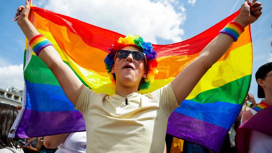 A participant waves a rainbow flag during the annual Belgian LGBT Pride Parade in central Brussels, Belgium, May 21, 2022. REUTERS/Johanna Geron