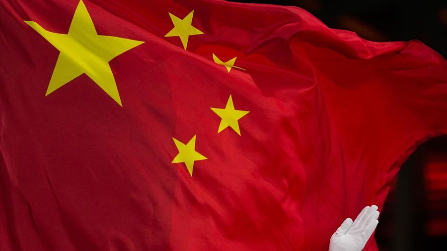 A Chinese flag is raised during a medal ceremony for the women's freestyle skiing big air at the 2022 Winter Olympics, Tuesday, Feb. 8, 2022, in Beijing. (AP Photo/Jae C. Hong)