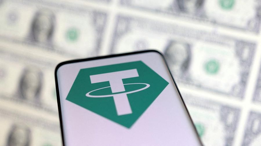 FILE PHOTO: Smartphone with Tether logo is placed on displayed U.S. dollars in this illustration taken, May 12, 2022. REUTERS/Dado Ruvic/Illustration/File Photo