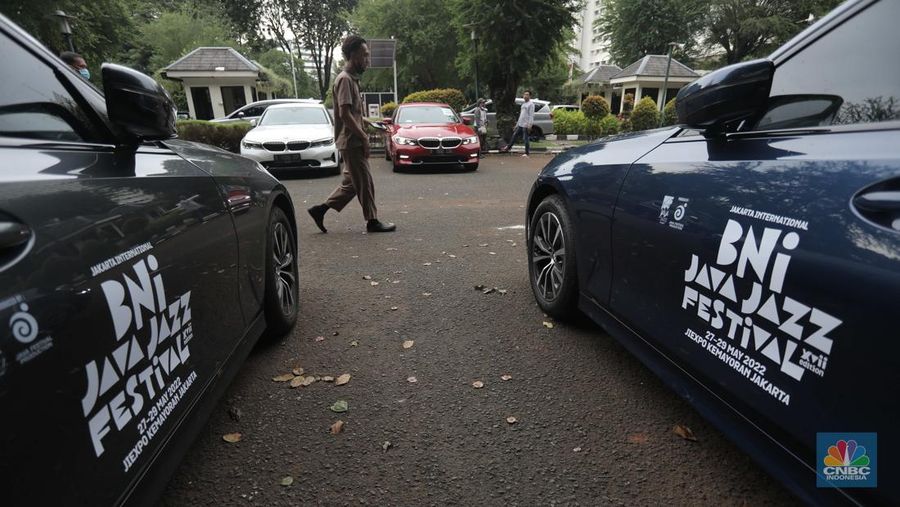 Warga melintas diparkiran BMW Seri 3 terbaru sebagai VIP Fleet dari BNI Java Jazz Festival 2022 kepada Dewi Gontha, President Director Java Festival Production di Jakarta, Rabu (25/5/2022). (CNBC Indonesia/ Muhammad Sabki)